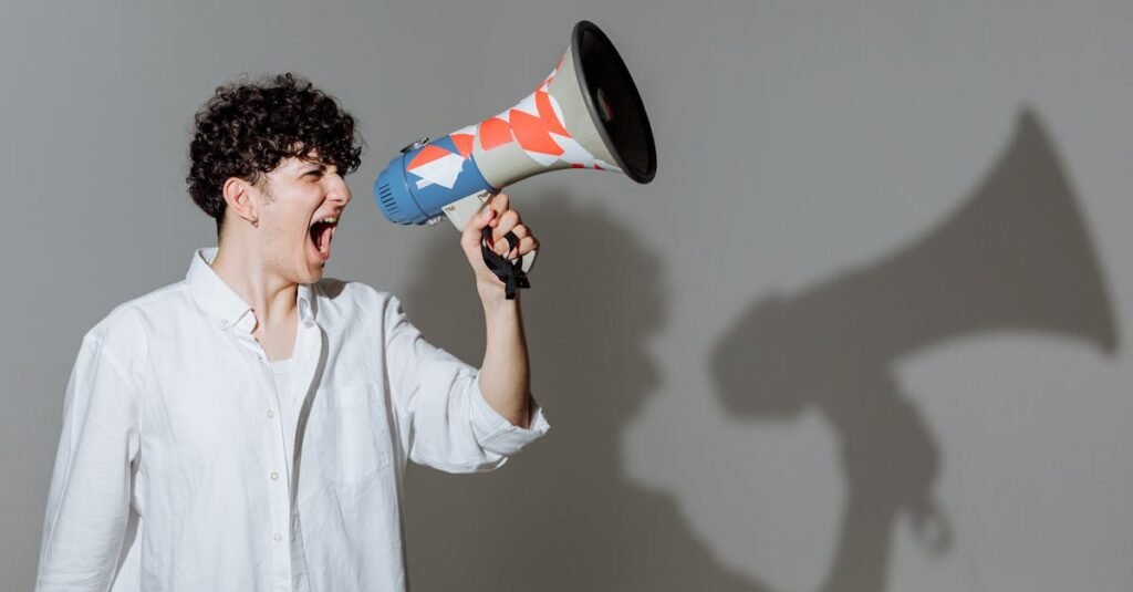 Curly Haired Man Shouting Through Megaphone